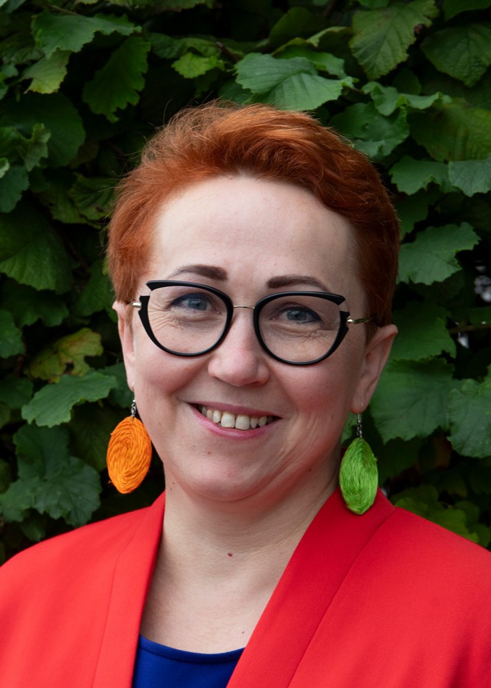 Headshot of woman smiling facing camera.