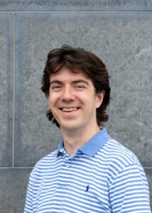 Headshot of man smiling to camera.