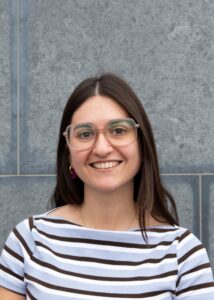 Headshot of woman smiling, facing camera.