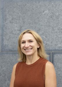Headshot of woman smiling to camera.