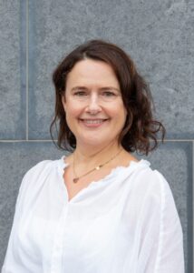 Headshot of woman smiling to camera.