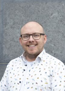 Headshot of man smiling to camera.