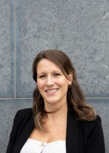 Headshot of woman smiling to camera.